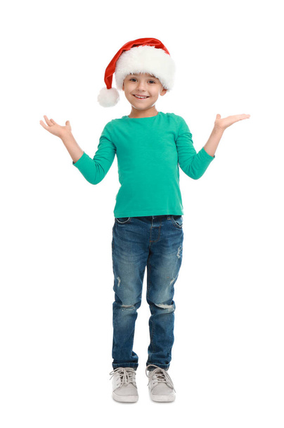 Cute little child wearing Santa hat on white background. Christmas holiday - Zdjęcie, obraz