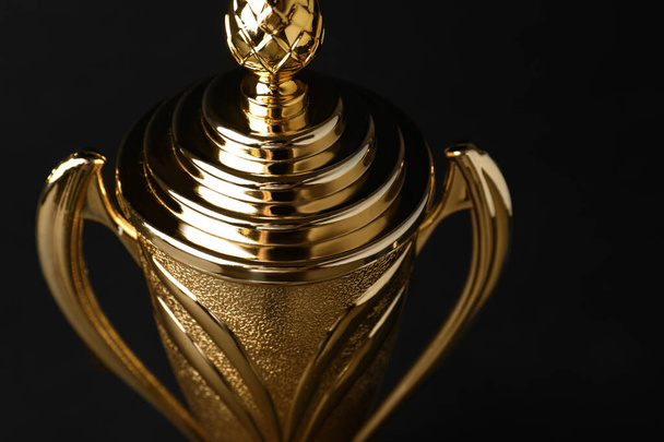 Golden trophy cup on black background, closeup - Photo, Image