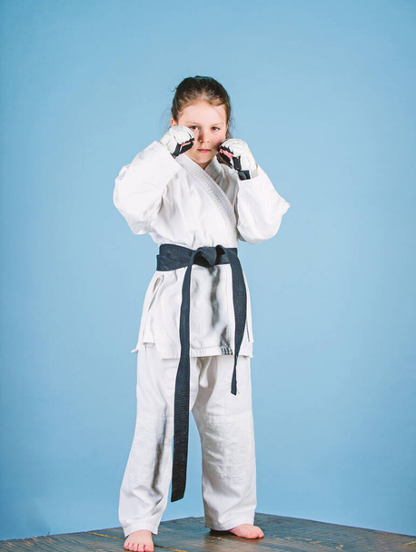 knockout. energy and activity for kids. little girl in gi sportswear. small girl in martial arts uniform. practicing Kung Fu. happy childhood. sport success in single combat. Stretching away stress - Zdjęcie, obraz