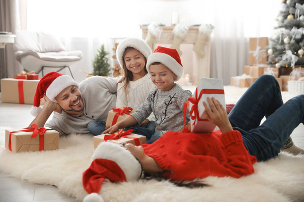 Happy family with Christmas gifts on floor at home - Fotoğraf, Görsel