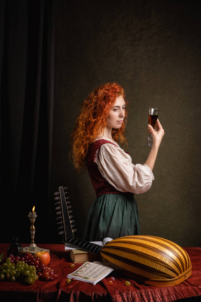 Red-haired girl in a historical suit plays the lute. Renaissance painting style - Photo, Image