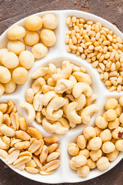 Tasty healthy snack from walnuts, hazelnuts, almonds and cashew, top view, close up - Fotografie, Obrázek