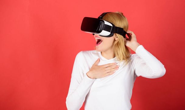 Pretty woman playing game in virtual reality glasses. The woman with glasses of virtual reality. Woman using VR device. Woman with oculus. - Fotografie, Obrázek
