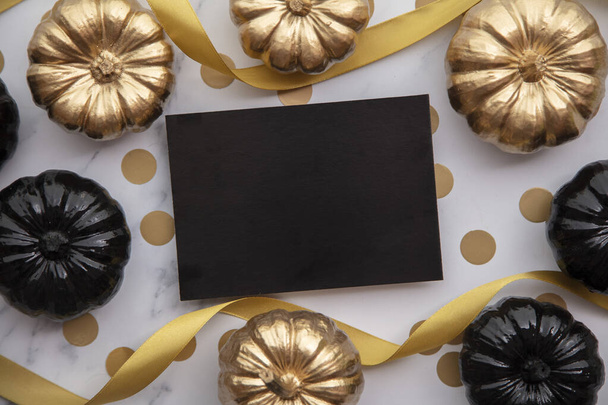 Luxury gold and black autumn pumpkin flat lay composition on a marble background - Zdjęcie, obraz