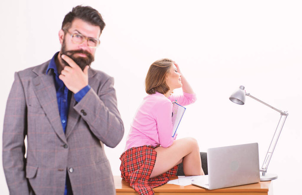 Sexy lady office worker. Sexy personal secretary. Full of desire. Having crush at work boost sexual desire. Bearded boss stand in front of sexy girl working laptop. Office manager or secretary - Foto, imagen