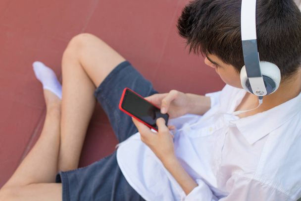 young teen with mobile phone and headphones - Photo, image