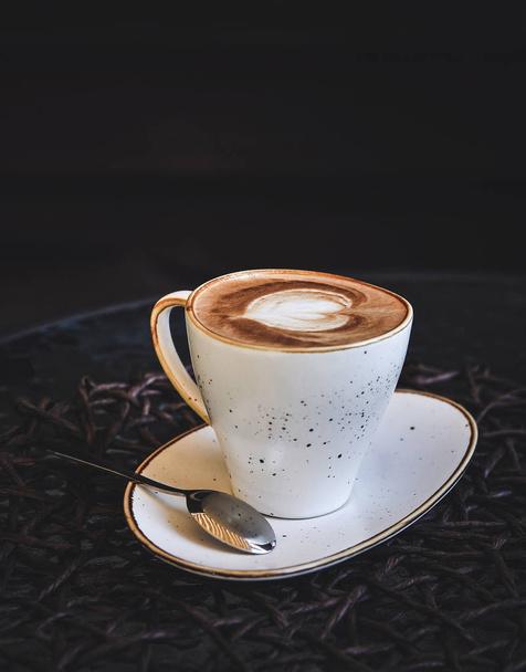 Coffee on glass table in dark key. - Foto, Imagen