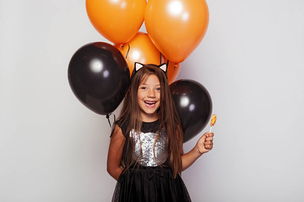 Cute laughing girl with candy and balloons - Foto, imagen
