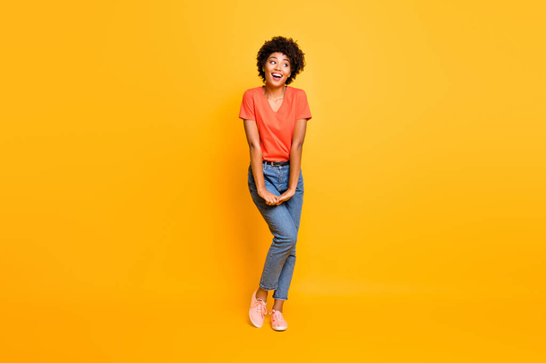 Full length body size photo of cheerful cute charming fascinating gorgeous black girlfriend wearing jeans denim t-shirt isolated over yellow vivid color background - Foto, imagen
