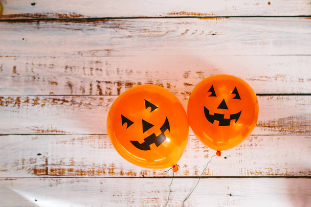 Orange pumpkin balloons for Halloween party on white wooden background. Happy Halloween. Holiday concept with colorful balloon. - Valokuva, kuva