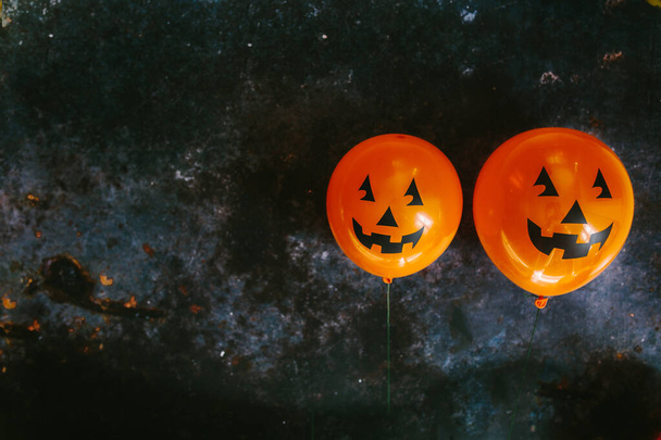 Orange pumpkin balloons for Halloween party on dark background. Happy Halloween. Holiday concept with colorful balloon. - Fotografie, Obrázek