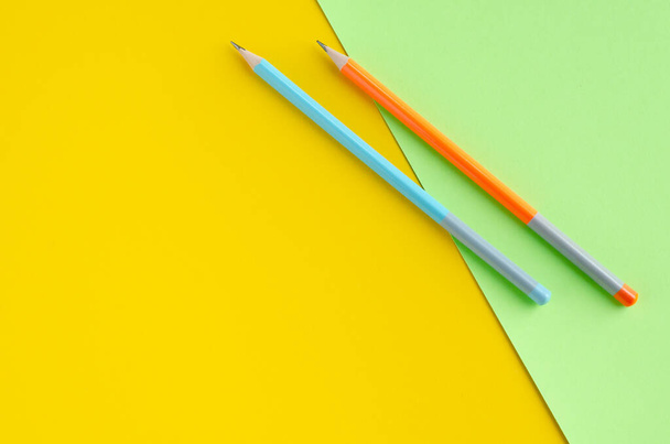 Colored pencils composition on yellow and green background. - Foto, Imagem