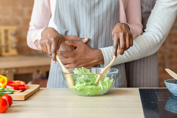 Cropped image of married couple cooking together at kitchen - Fotó, kép