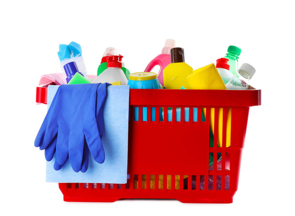 Shopping basket with different detergents, rag and gloves on white background - Φωτογραφία, εικόνα