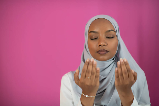 African Muslim woman makes traditional prayer to God - Фото, изображение