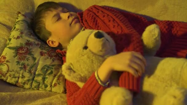 Boy sleeping with bear toy, then he wakes up and plays - Video