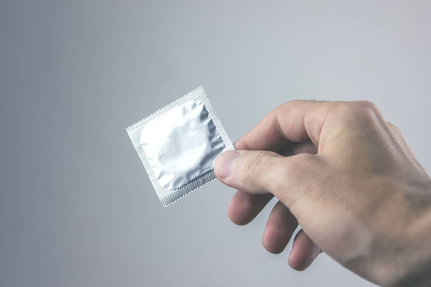 Closeup image of a young man with a condom - Fotografie, Obrázek
