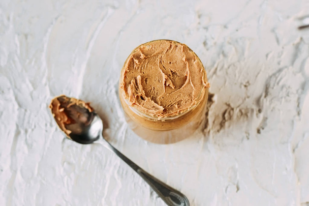 thick peanut butter in a jar close-up. Healthy eatin - Photo, Image
