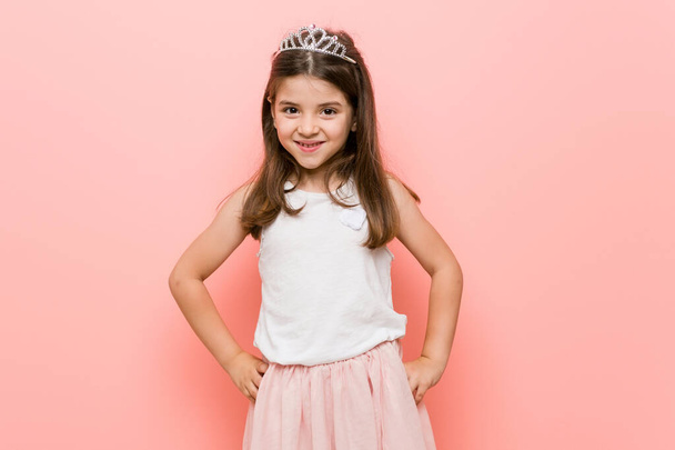 Little girl wearing a princess look confident keeping hands on hips. - Photo, Image