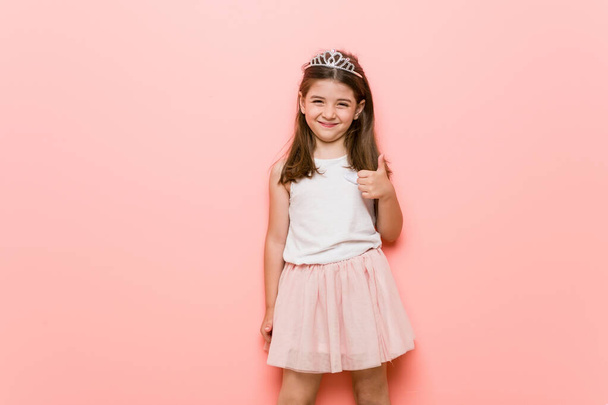 Little girl wearing a princess look smiling and raising thumb up - Photo, Image