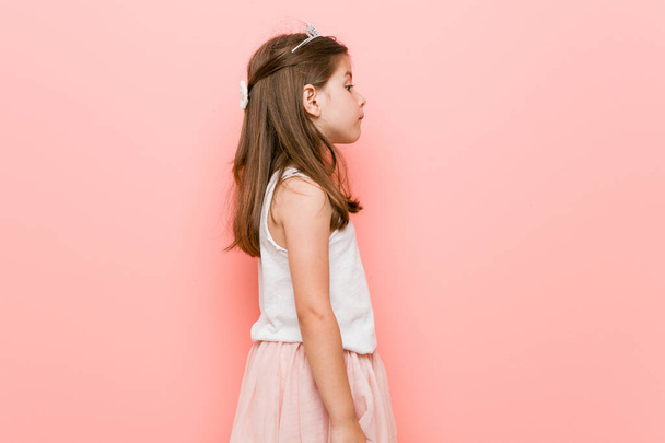 Little girl wearing a princess look gazing left, sideways pose. - Fotó, kép