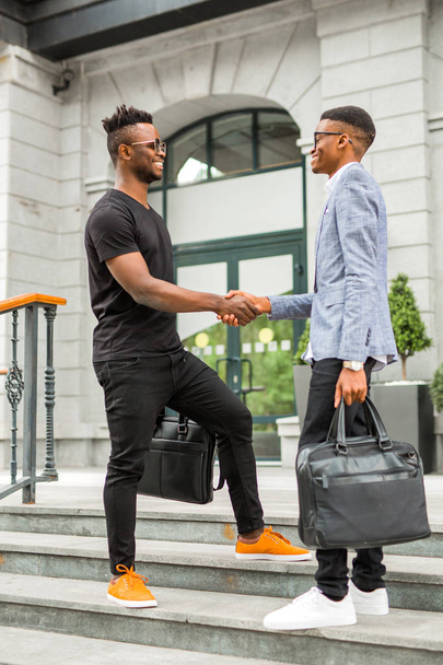 meeting of two handsome young african men near the building - Zdjęcie, obraz
