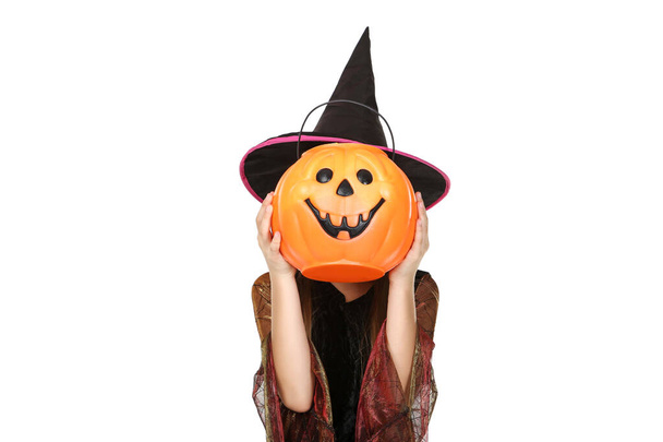 Young girl in halloween costume holding pumpkin bucket with cand - Fotoğraf, Görsel