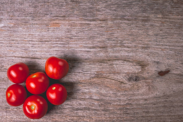ripe tomatoes on wooden board in studio - Photo, Image