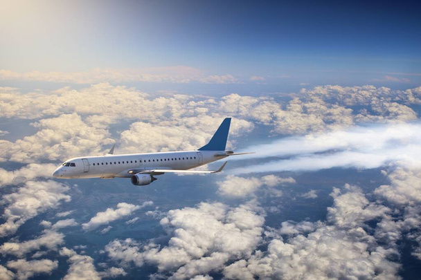 passenger plane is flying above the clouds - Valokuva, kuva