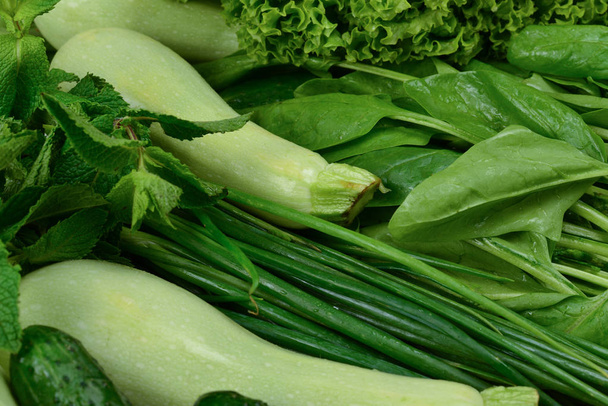 Fresh green vegetables and herbs as a background.   - Photo, image