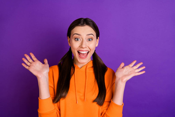 Portrait of astonished cute funky millennial girl hear incredible news information scream wow omg wear modern youth clothes sportswear isolated over violet purple color background - Foto, Imagen