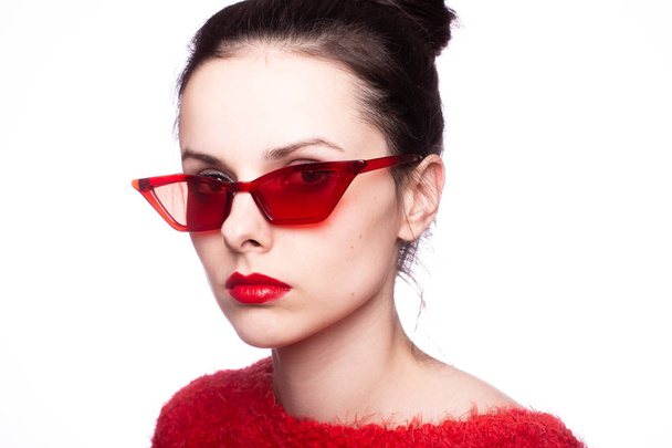 young woman in red sunglasses, red lipstick, red sweater - Foto, imagen