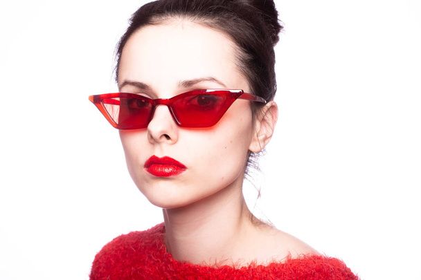 young woman in red sunglasses, red lipstick, red sweater - Foto, Imagen