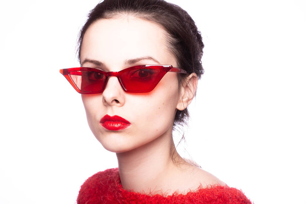 young woman in red sunglasses, red lipstick, red sweater - Фото, зображення