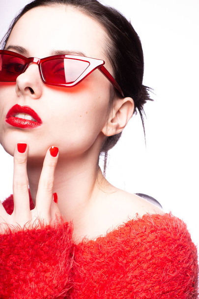 young woman in red sunglasses, red lipstick, red sweater - Zdjęcie, obraz