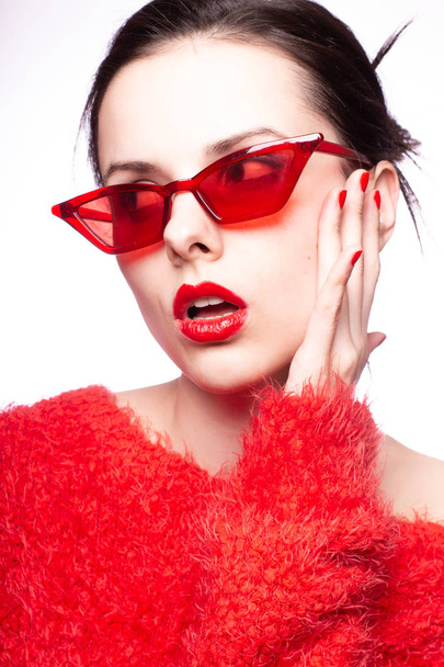 young woman in red sunglasses, red lipstick, red sweater - Фото, зображення