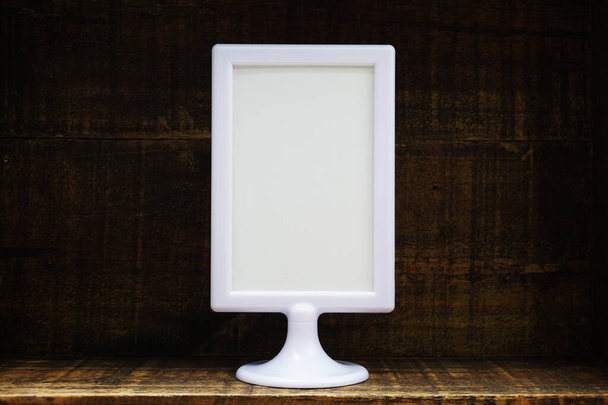 Blank Display frame stand on wooden background - Fotografie, Obrázek