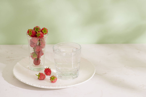 Fresh raspberries in a glass beaker isolated on light background - Photo, image