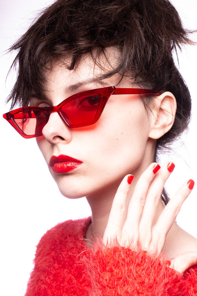 young woman in red sunglasses, red lipstick, red sweater - Foto, Imagem
