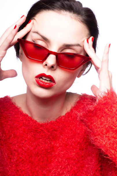 young woman in red sunglasses, red lipstick, red sweater - Fotografie, Obrázek