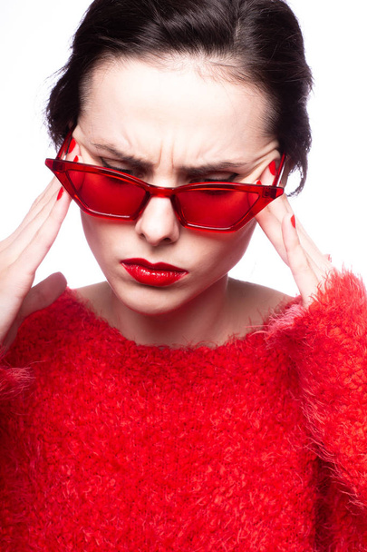 young woman in red sunglasses, red lipstick, red sweater - Foto, imagen