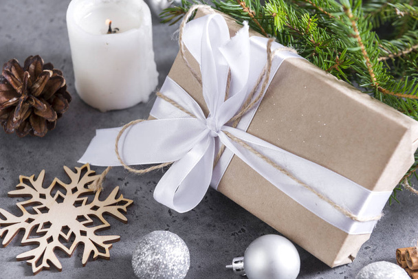 gift box with white ribbon and rope, silver balls, spruce branch - Φωτογραφία, εικόνα