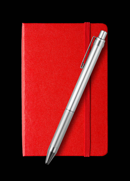 Red closed notebook and pen isolated on black - Фото, зображення