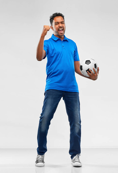 football fan with soccer ball celebrating victory - 写真・画像