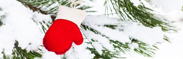 Christmas Background. Red and White Felt Mitten on a Natural Background. Selective focus. - Photo, image