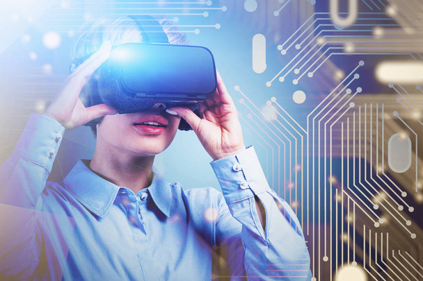 Young woman in VR headset, circuit interface - Fotografie, Obrázek