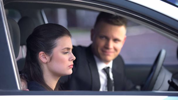 Unhappy wife and husband sitting in car after quarrel, risk of divorce, conflict - Valokuva, kuva