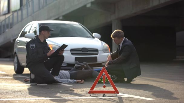 Emergency sign on road, policeman writing report, car collision with bicycle - Fotografie, Obrázek