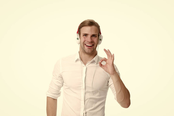 Man listening favourite song in headphones and singing. Guy with earphones listen music. Man satisfied face enjoy listening music headphones. Modern music gadget. Music monthly subscription - Фото, изображение