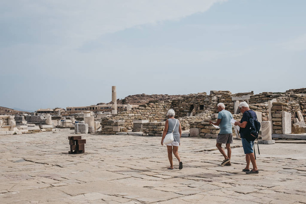 People walking amongst the ruins on island of Delos, Greece. - Фото, изображение